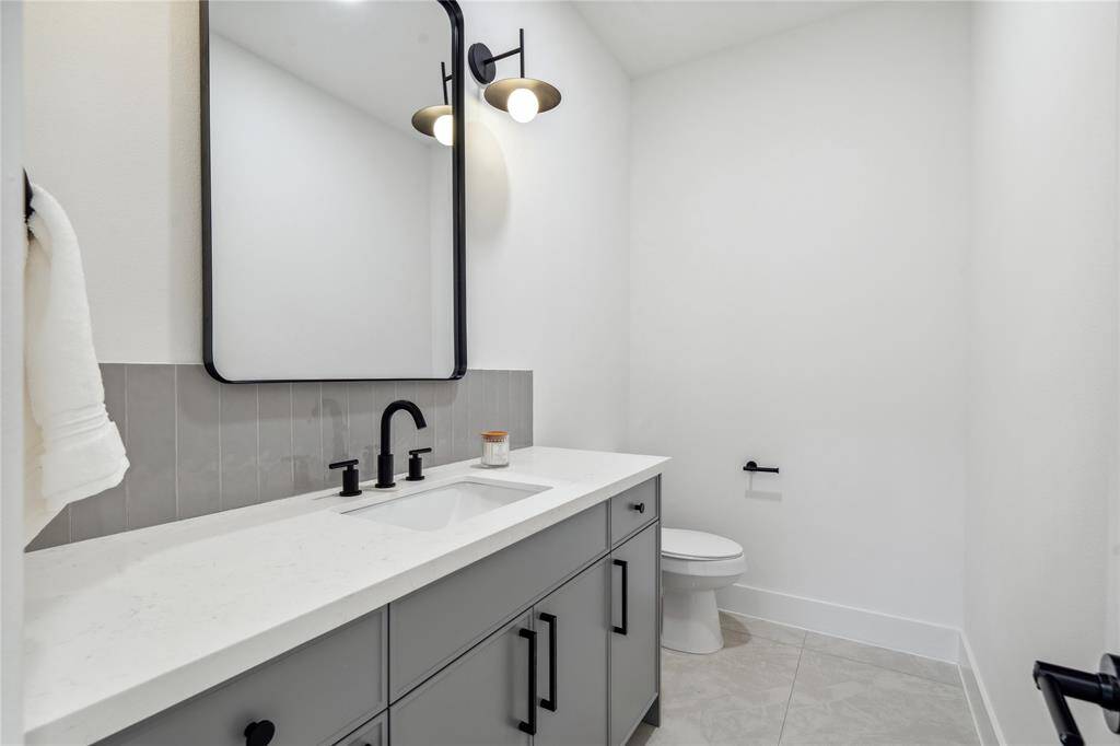 The powder room keeps the flow of the design found throughout the home.
