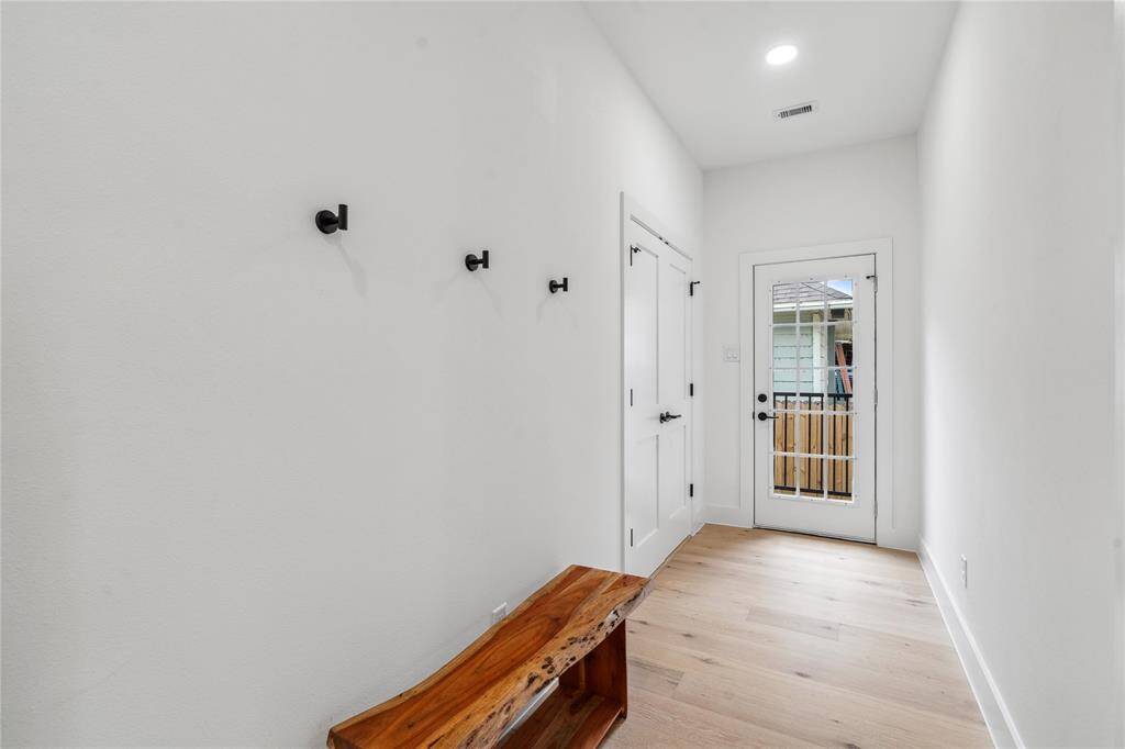 The second entry to the home is a convenient side entrance with coat hangers perfect for winter.