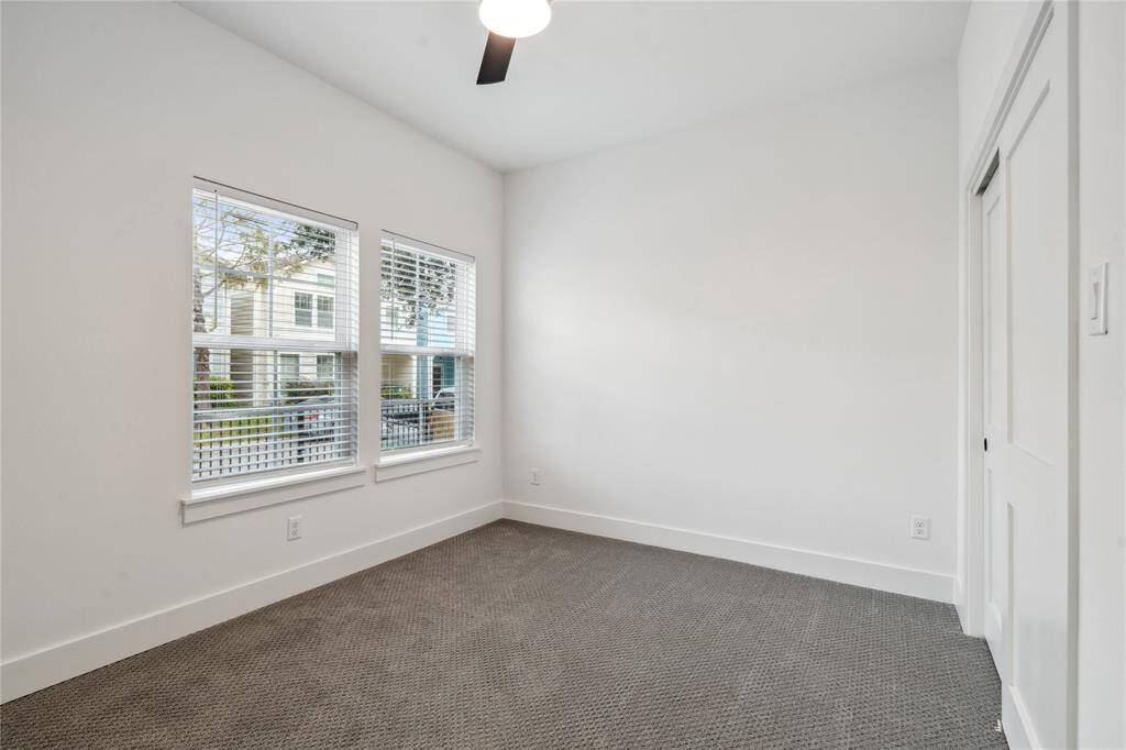 The secondary rooms provide ample space for either an office or a secondary bedroom, equipped with upgraded pattern carpet.