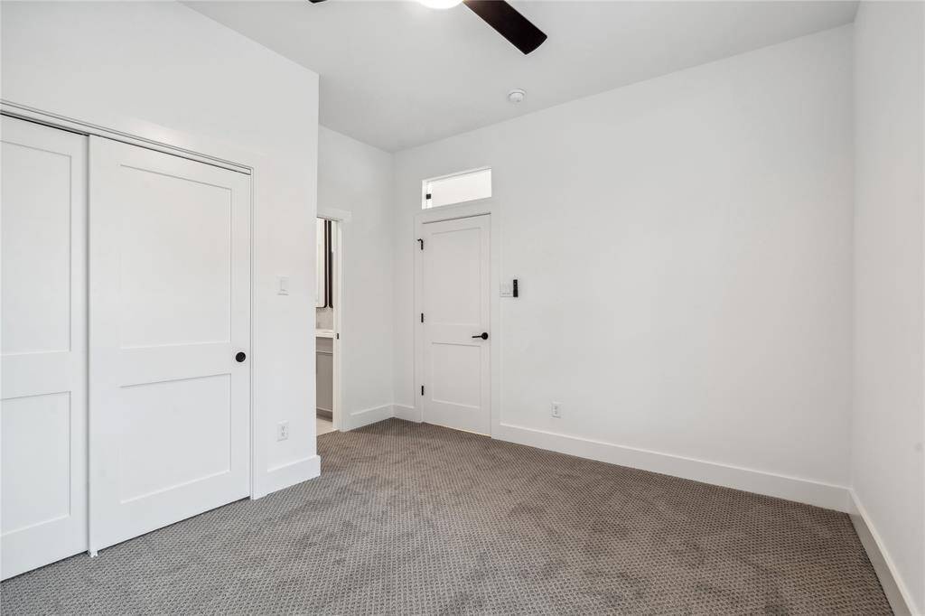 Another view with the secondary bedroom with a nice transom window above the door.