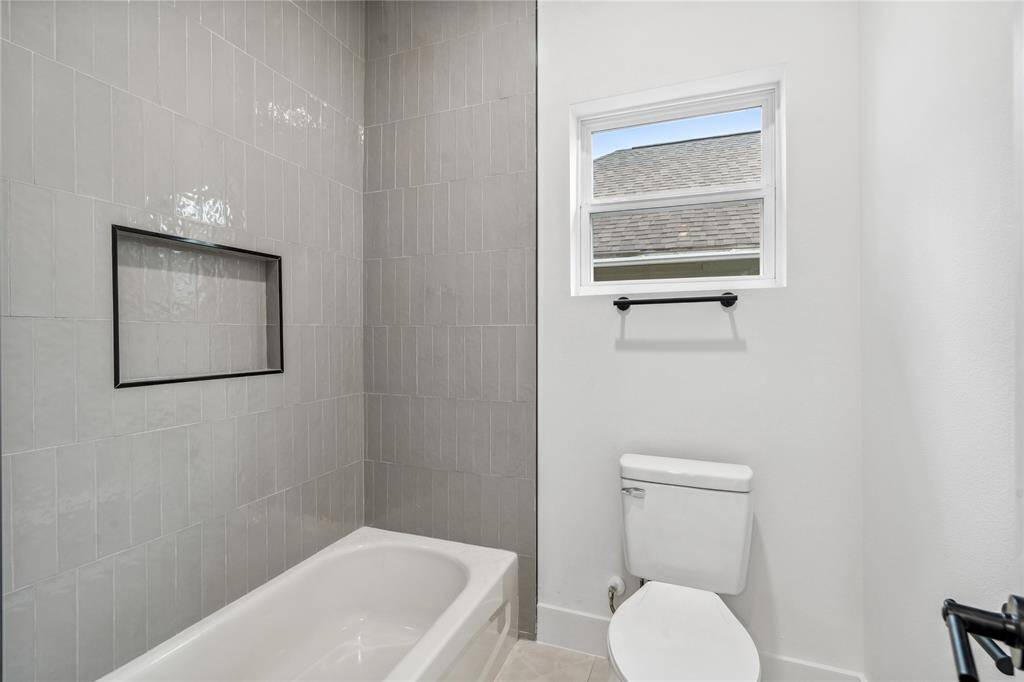 The secondary bathroom has a private full size bath, featuring tub and shower.