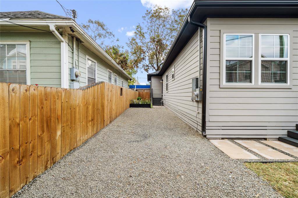 Flagstone driveway that fits 3 cars alongside side street parking.