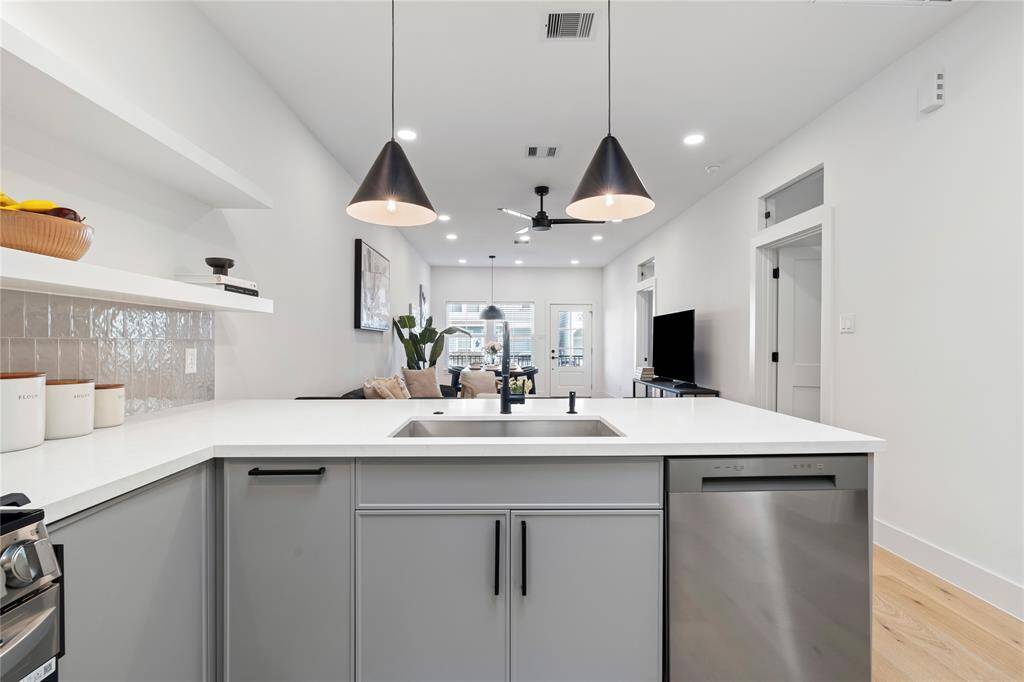 A deep farmhouse stainless steel sink is a perfect blend for this kitchen with matte finished hardware.