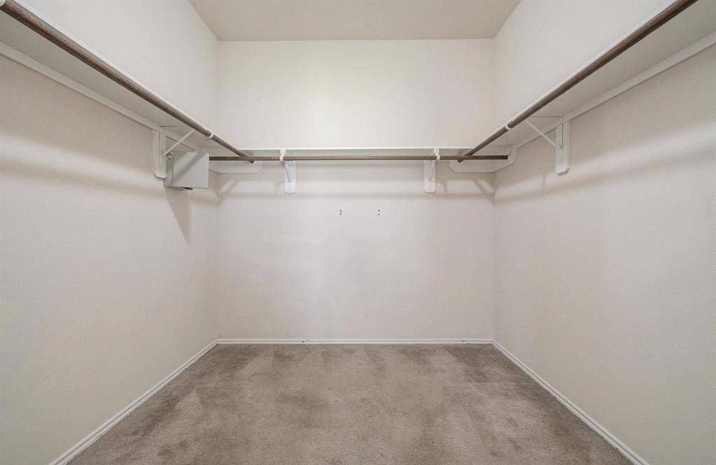 Primary bedroom walk-in closet
