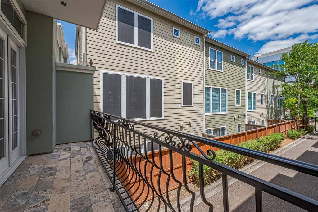 From the second-floor balcony, take in views of the long driveway below. With partial covering overhead, this space is ideal for morning coffee or evening lounging.