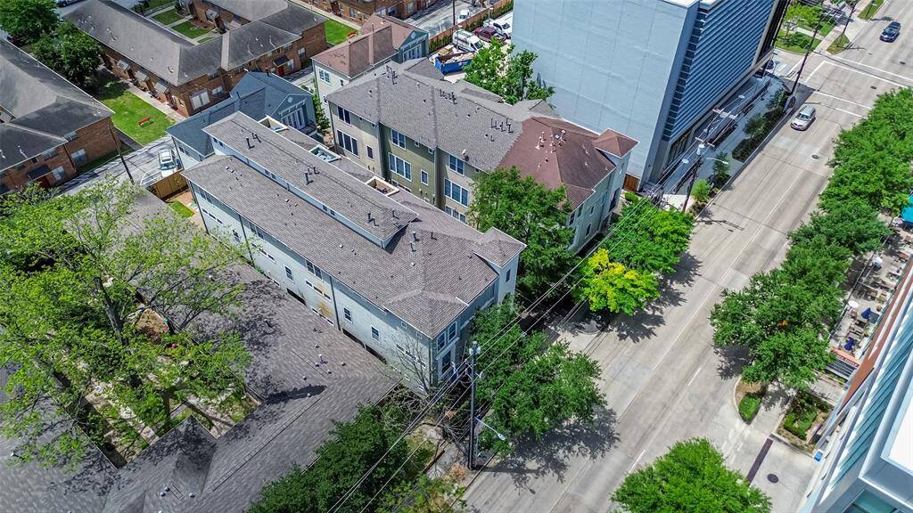 Surrounded by distinctive residences and tree-lined streets, this aerial view highlights the home’s placement within an architecturally rich neighborhood.