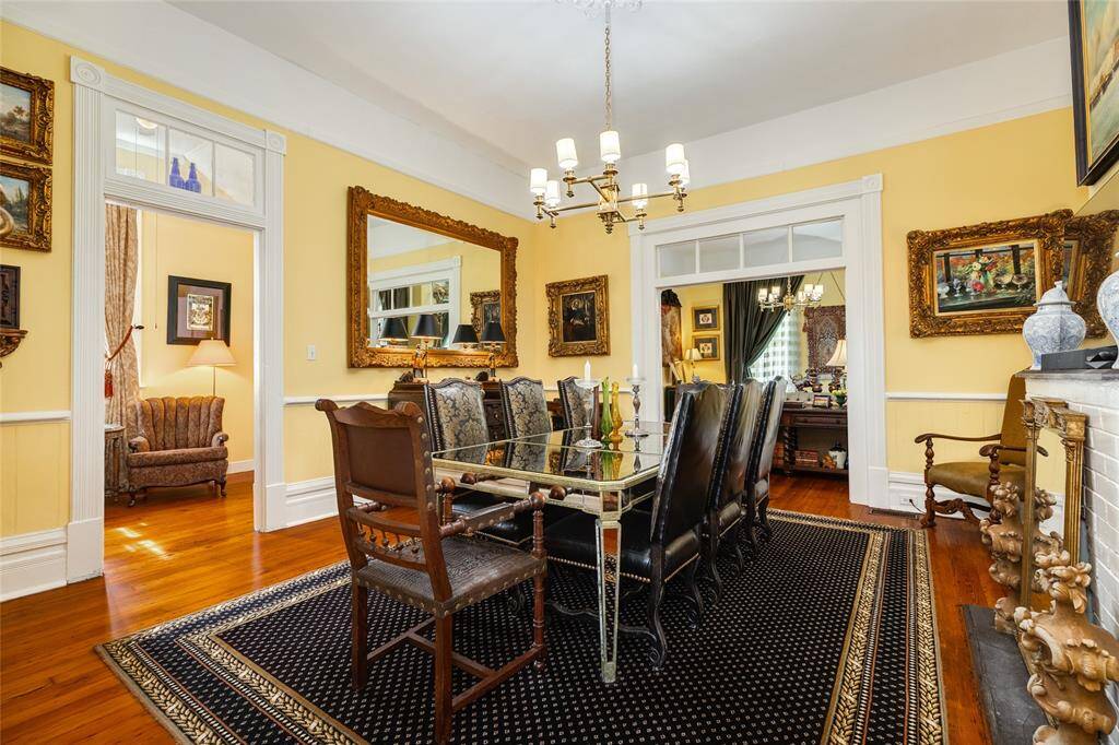 Flowing dining area with entrance to reading nook and living area with beautiful transoms and woodwork.