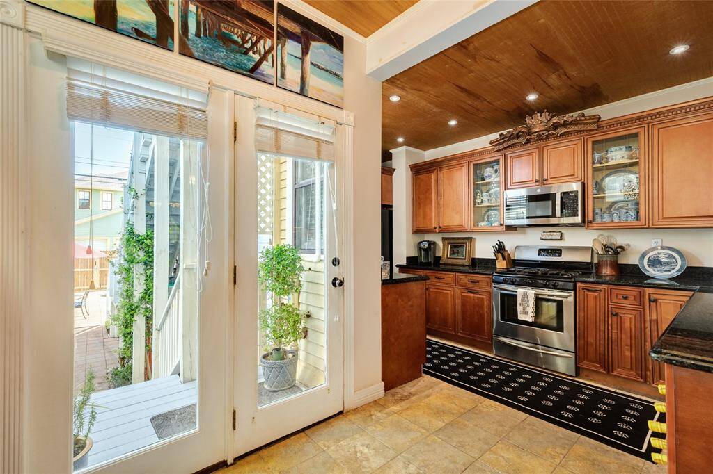 Nicely arrange kitchen with back entrance.
