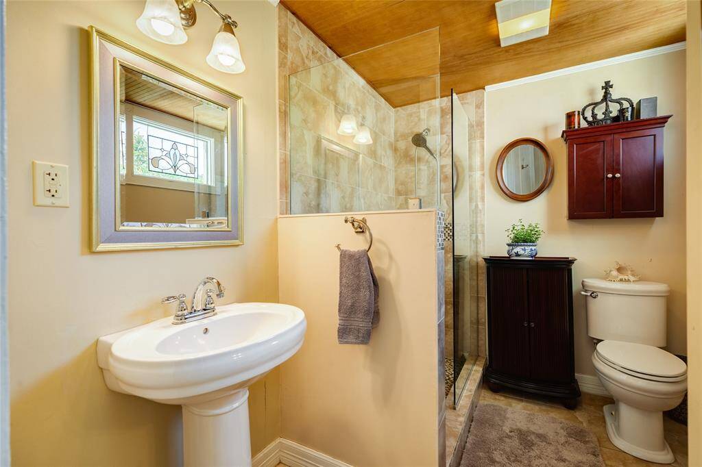 Downstairs bathroom with updated tiled walk in shower and flooring.