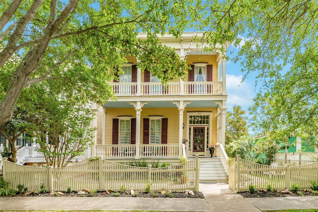 Inviting front entrance to home with beautiful oak trees cascading in front of home.