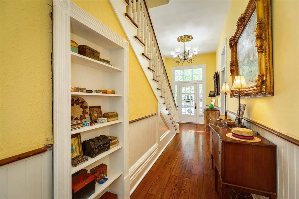 Grand Foyer with bookshelf that opens as secret storage.