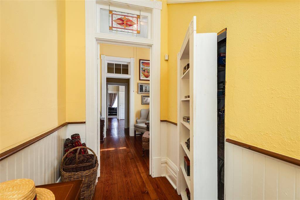 Foyer showing bookshelf opening to secret storage.