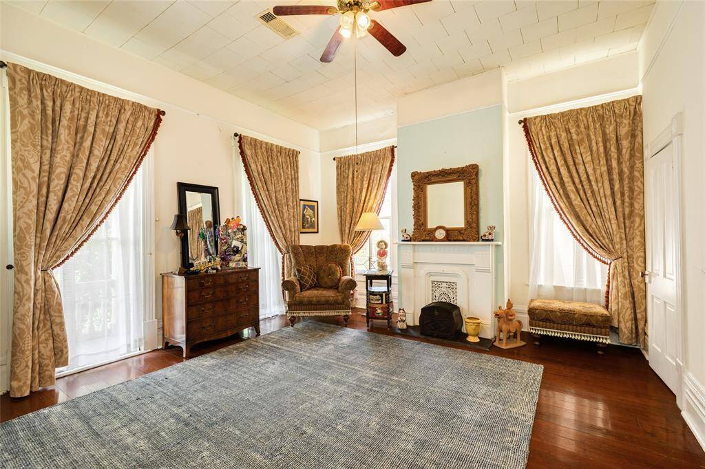 Upper level front living space or bedroom with closet and mock fireplace.