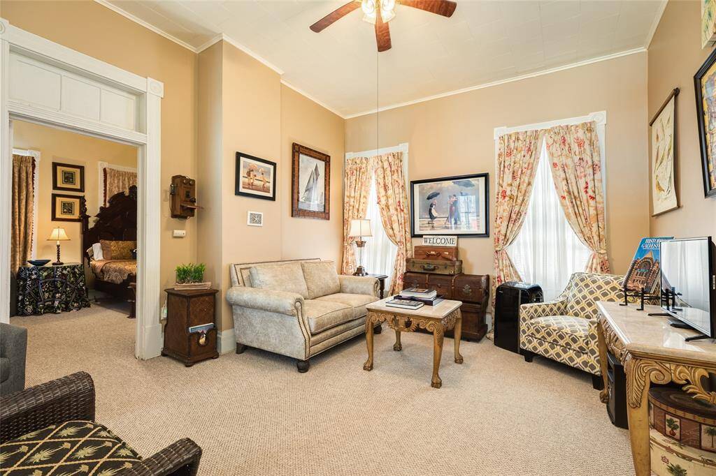 Upper level living quarters, kitchen, bedroom with separate entrance to home through back or could be converted back to main house living.  Would make great primary suite, apartment for long term rental or Airbnb.