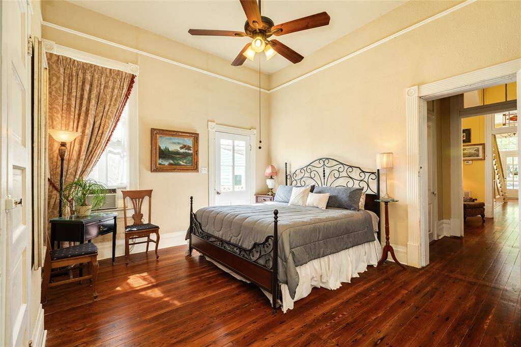Ground level bedroom that is incorporated into Main House but could be closed off to rent long term or Airbnb.  Would make great primary bedroom suite on the first level. Has kitchen and living space.  Located on the back portion of home.  Bedroom showing distance front entrance to home.