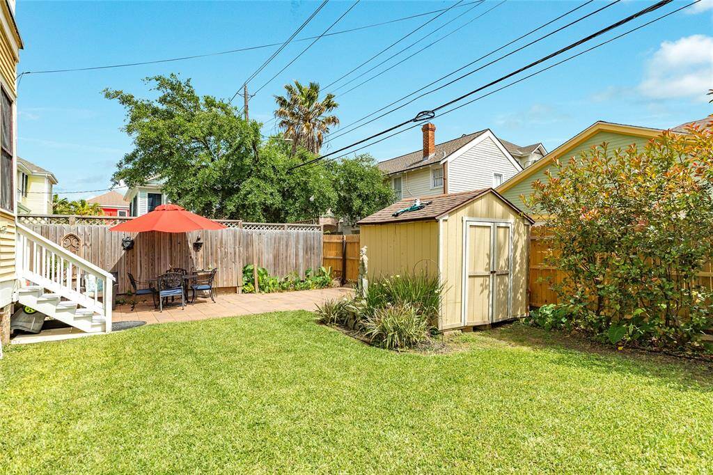 Large back yard with storage, fully fenced and alley entrance to parking.