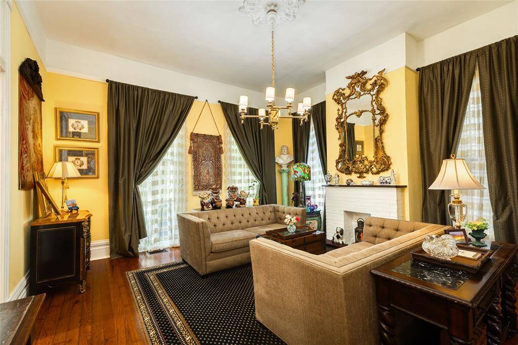 Front living off the foyer with 13 inch baseboards, 12 foot ceilings, ceiling ornament with chandelier from the Historic Hotel in Galveston, and fireplace with gas connections.