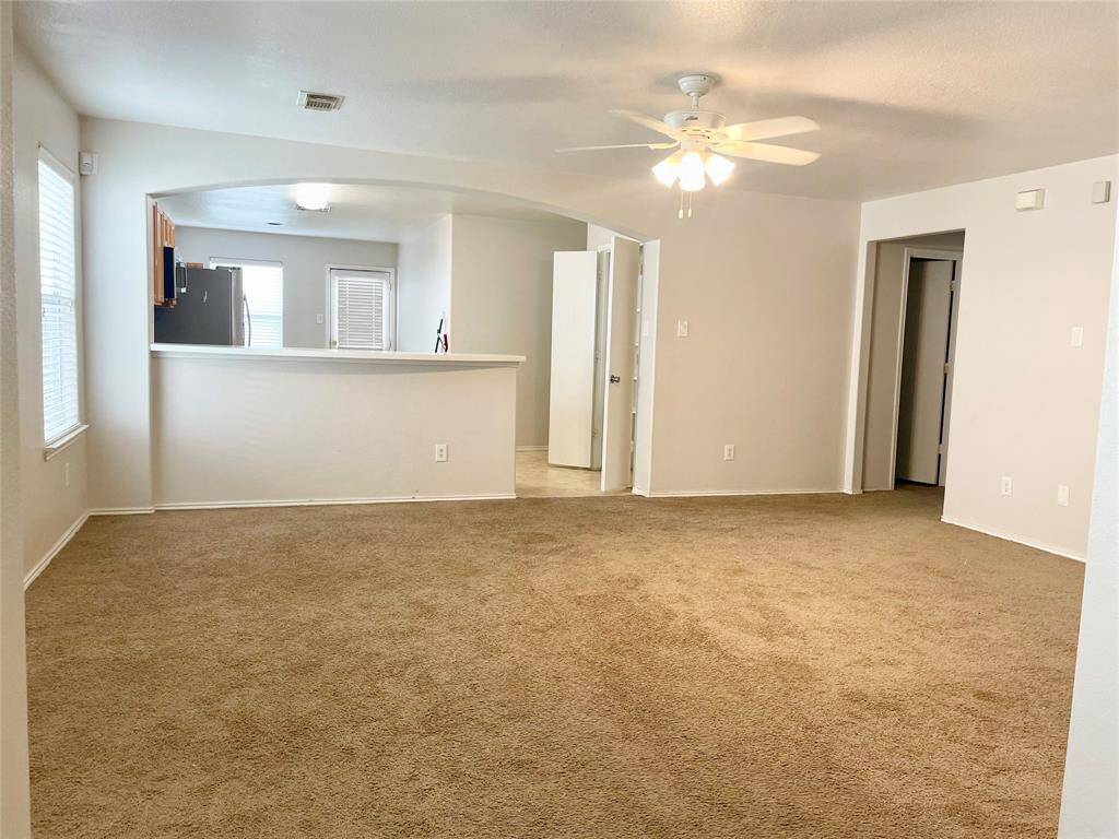 Large living room with ceiling fan.