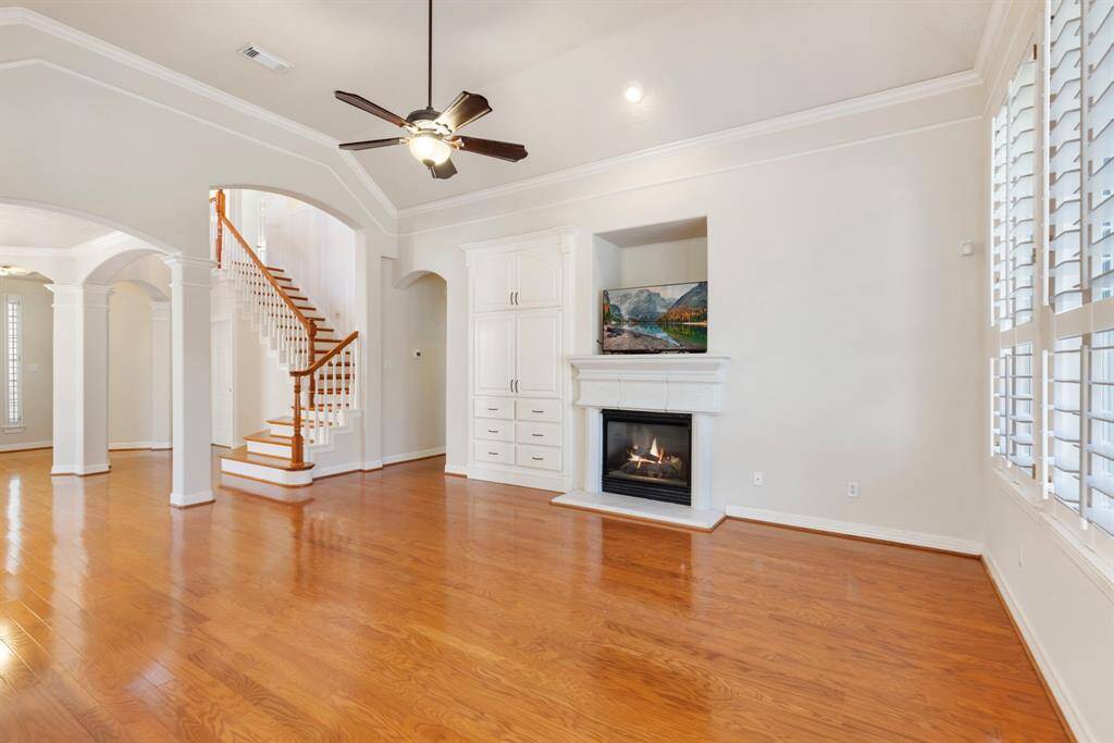The high ceilings, neutral colors, hardwood floors, upscale mouldings and plantation shutters really elevate this space.