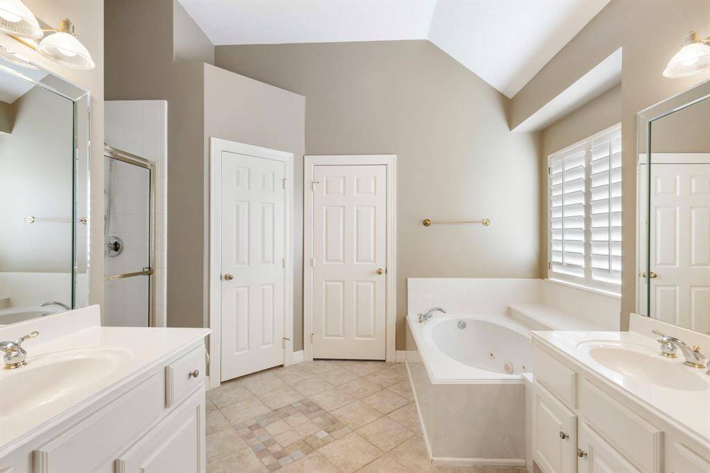 The primary bathroom features double vanities and a large walk-in closet.