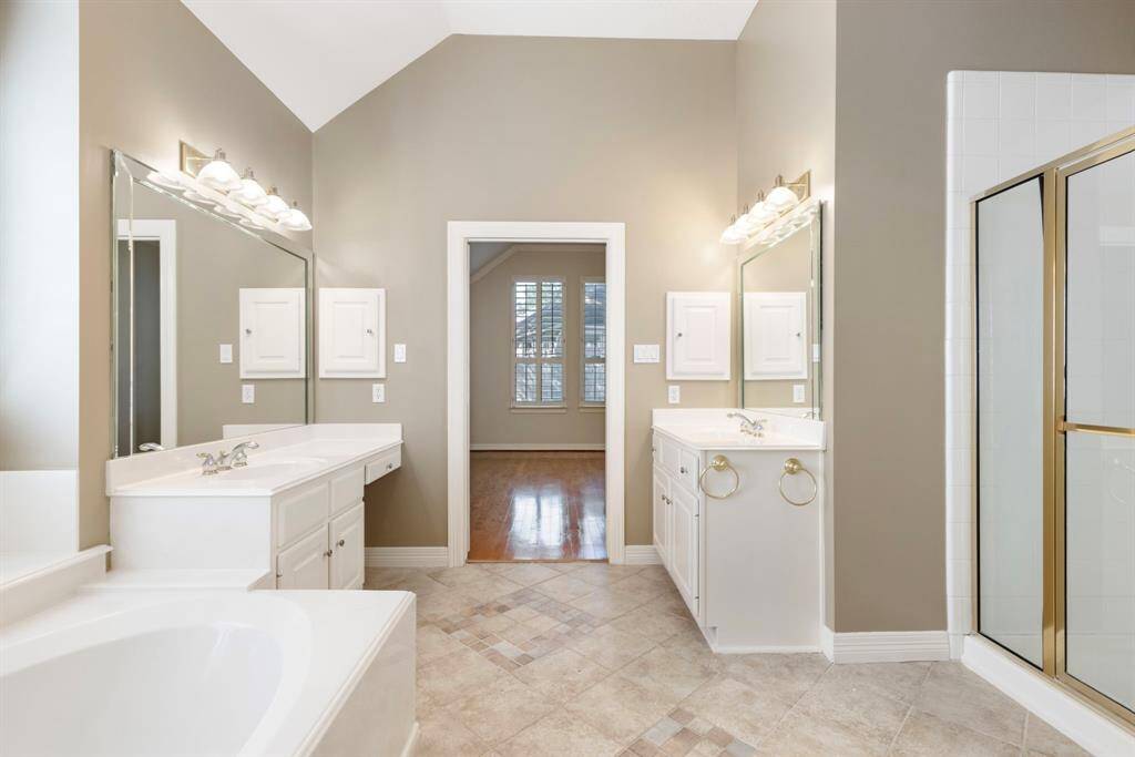 The primary bathroom conveniently offers a separate shower plus jacuzzi tub.