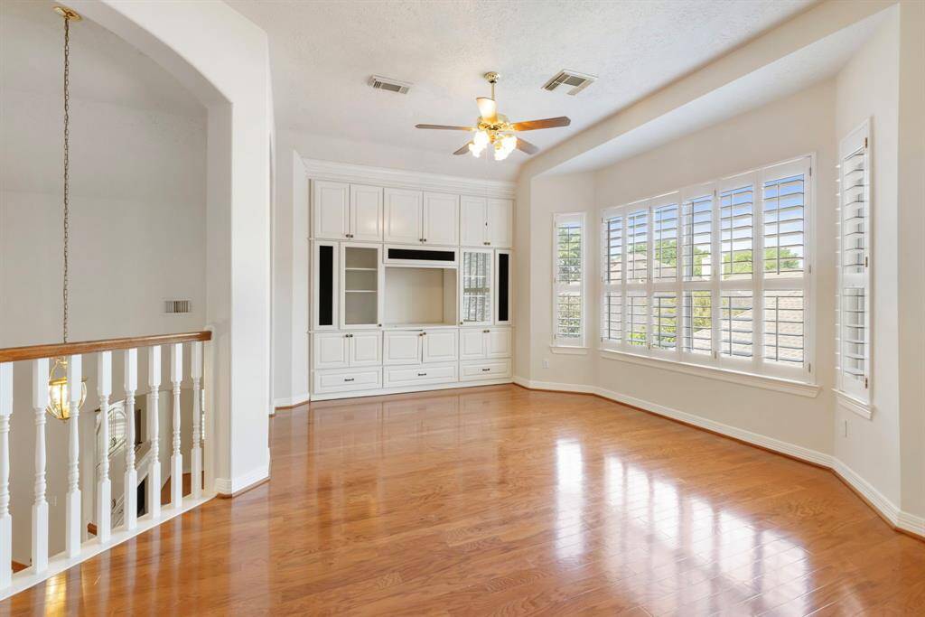 This upstairs gameroom is sure to be the gathering place of the home.