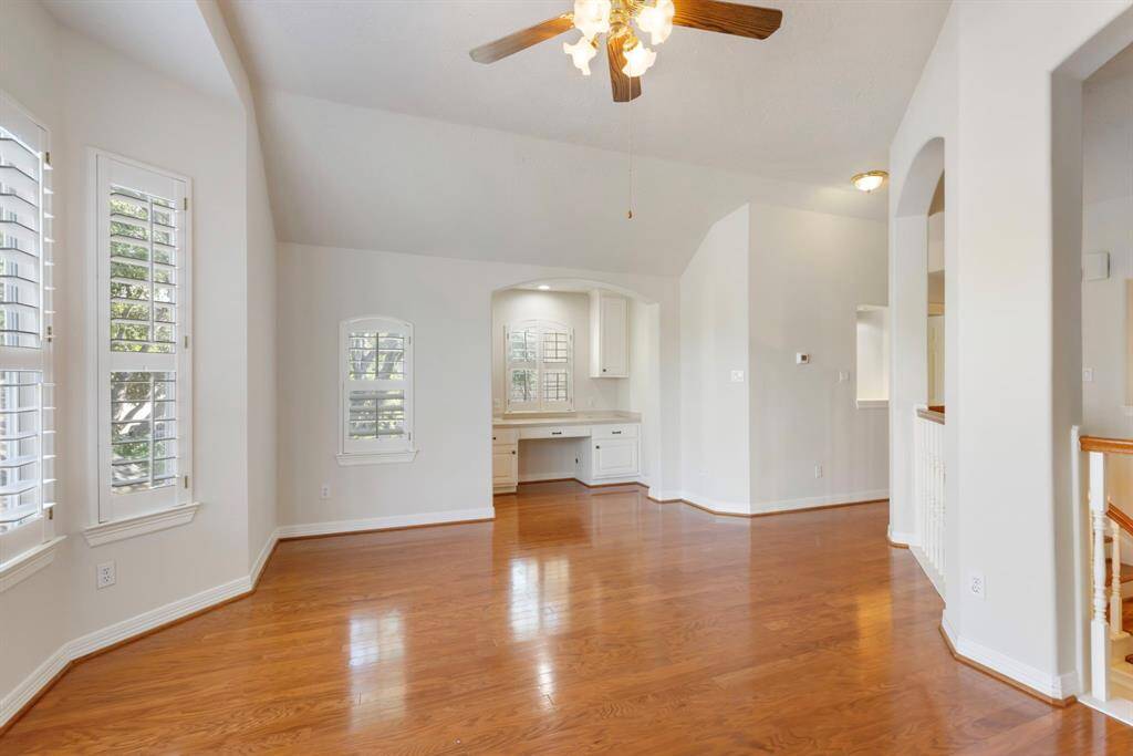 This gameroom not only features walls of windows with plantation shutters, but it also has this awesome bonus built-in desk area.