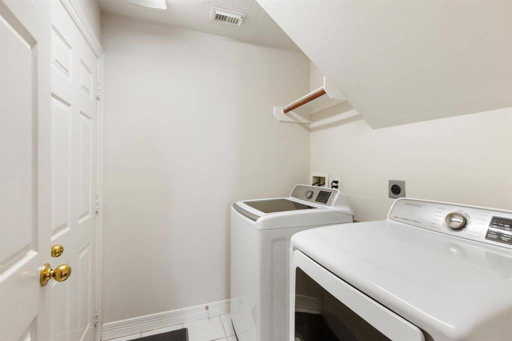 The utility room leads to the garage and bonus: Washer and dyer stay!
