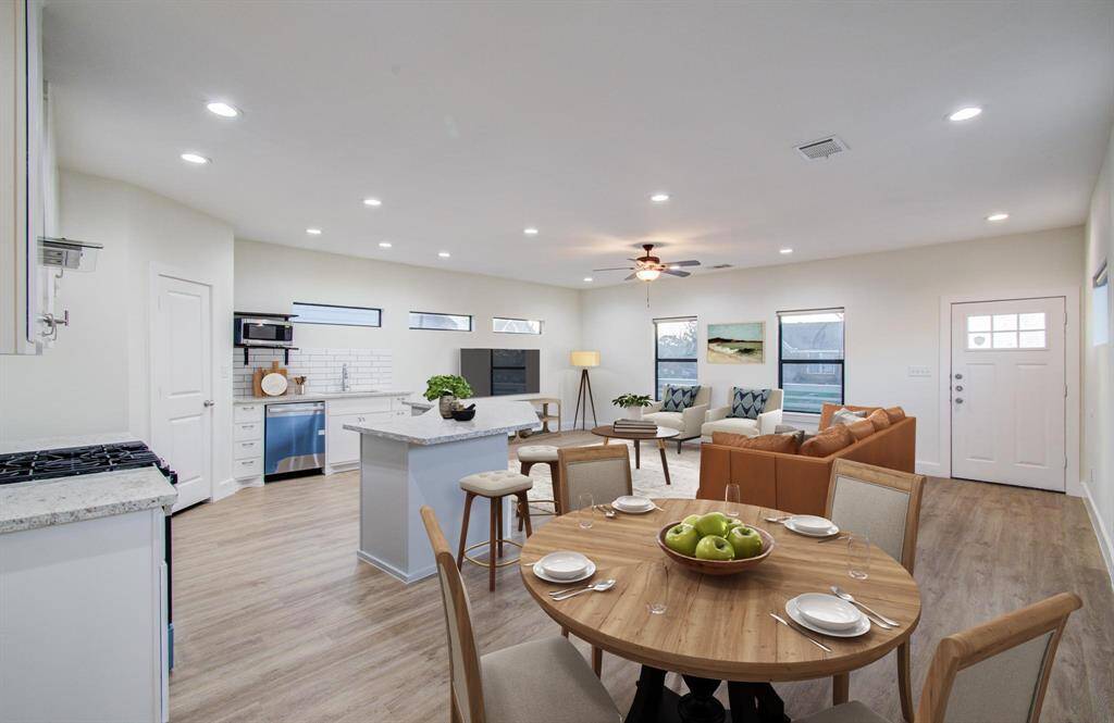 Welcome home! Living room and kitchen virtually staged.