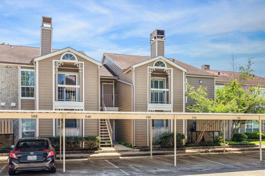 The condo's balcony is on the top right of the photo and the assigned covered parking spot is #542