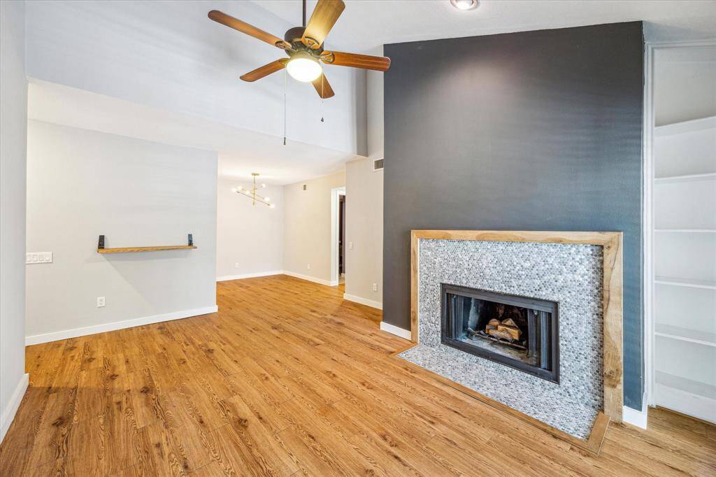 Additional view of the living room looking into the dining area. Enjoy the wood burning fireplace!