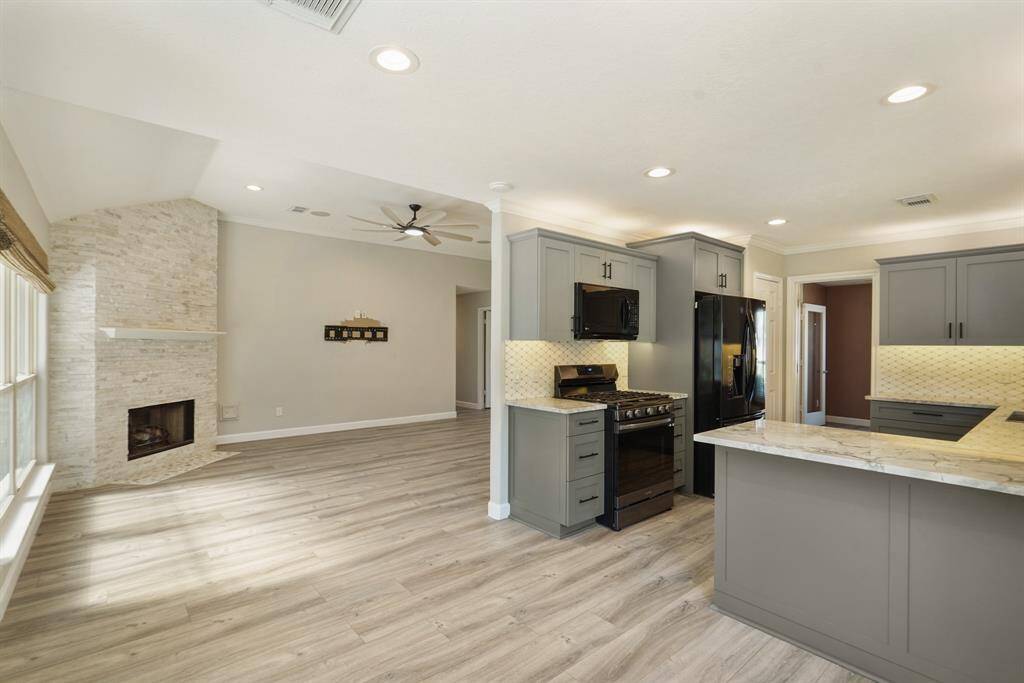 Photo shows kitchen and living area from breakfast nook.