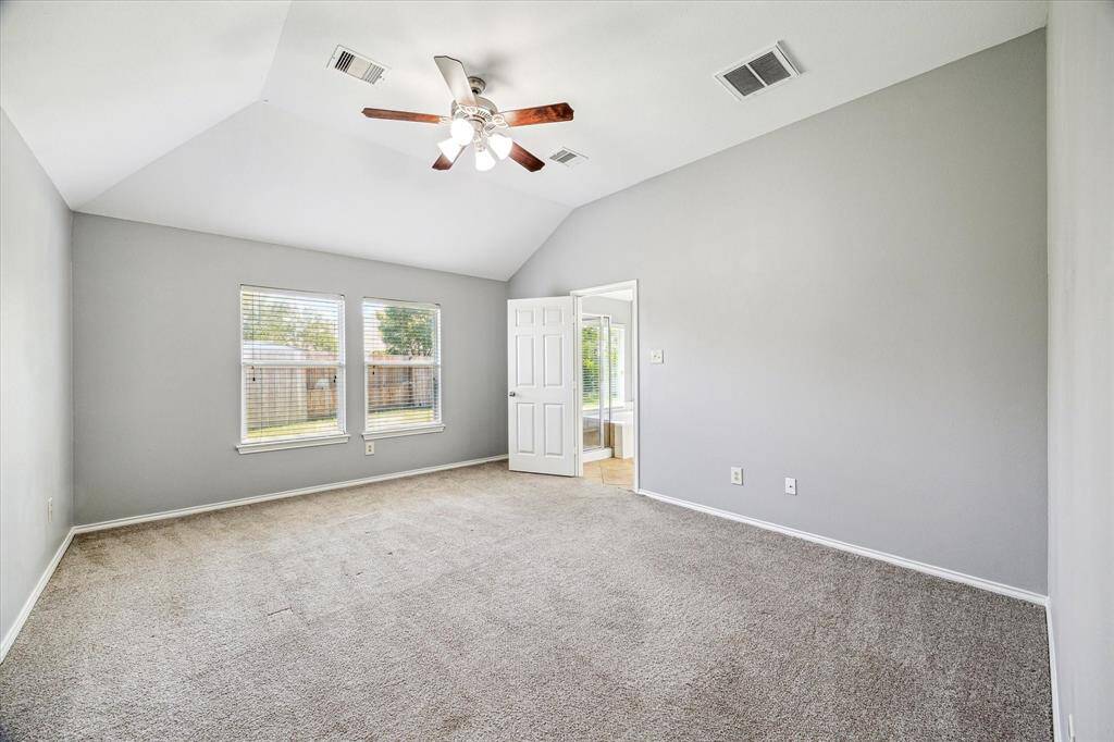 The Large Primary Bedroom w/ Fresh Paint, Ceiling Fan and En-Suite Bathroom