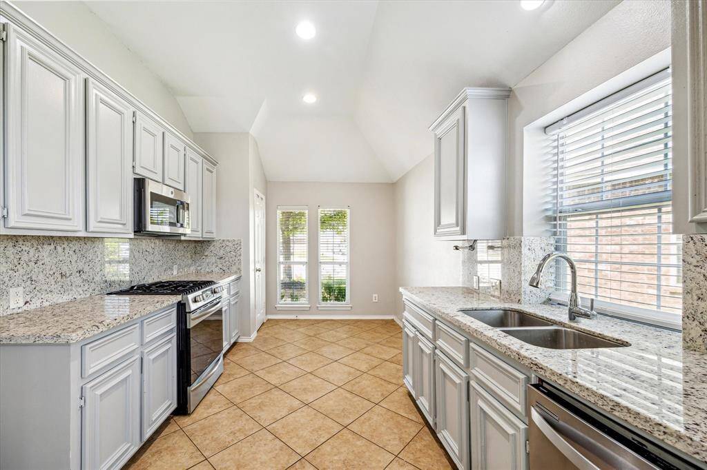 The Kitchen Highlights Great Storage Space, Granite Counters & Backsplash, Canned Lighting and a Window Behind the Sink for Natural Light