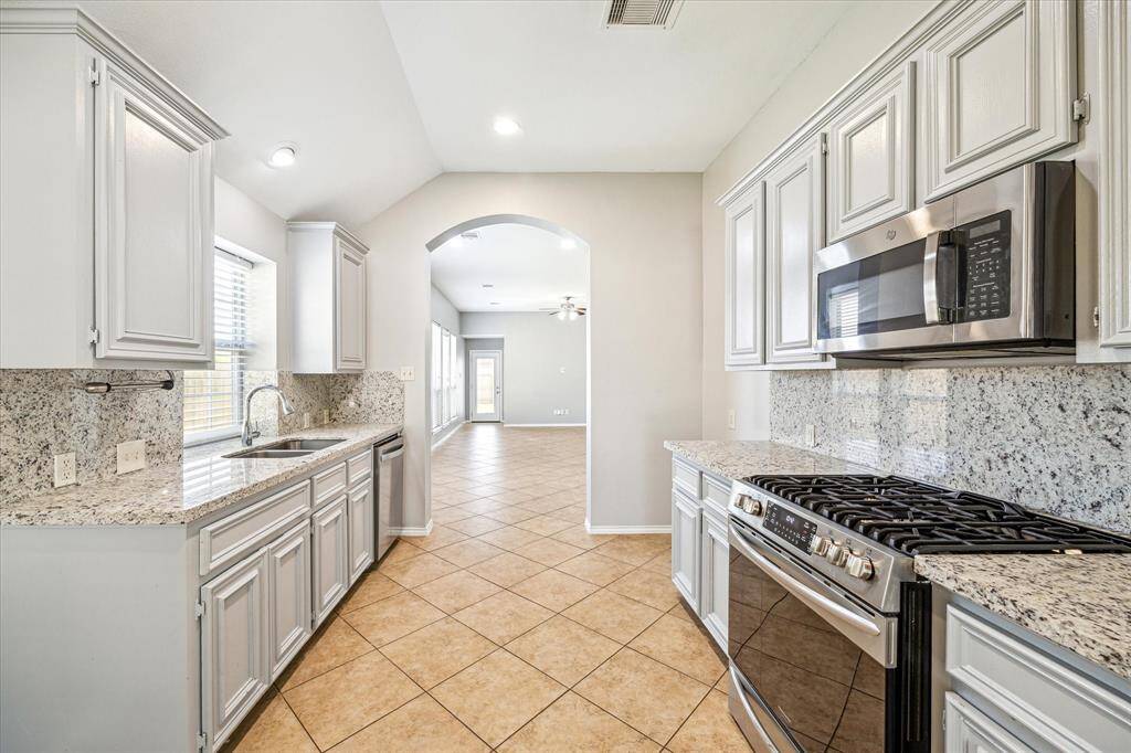 Another View of the Kitchen Showing the Gas Range and Matching Stainless Steel Appliances