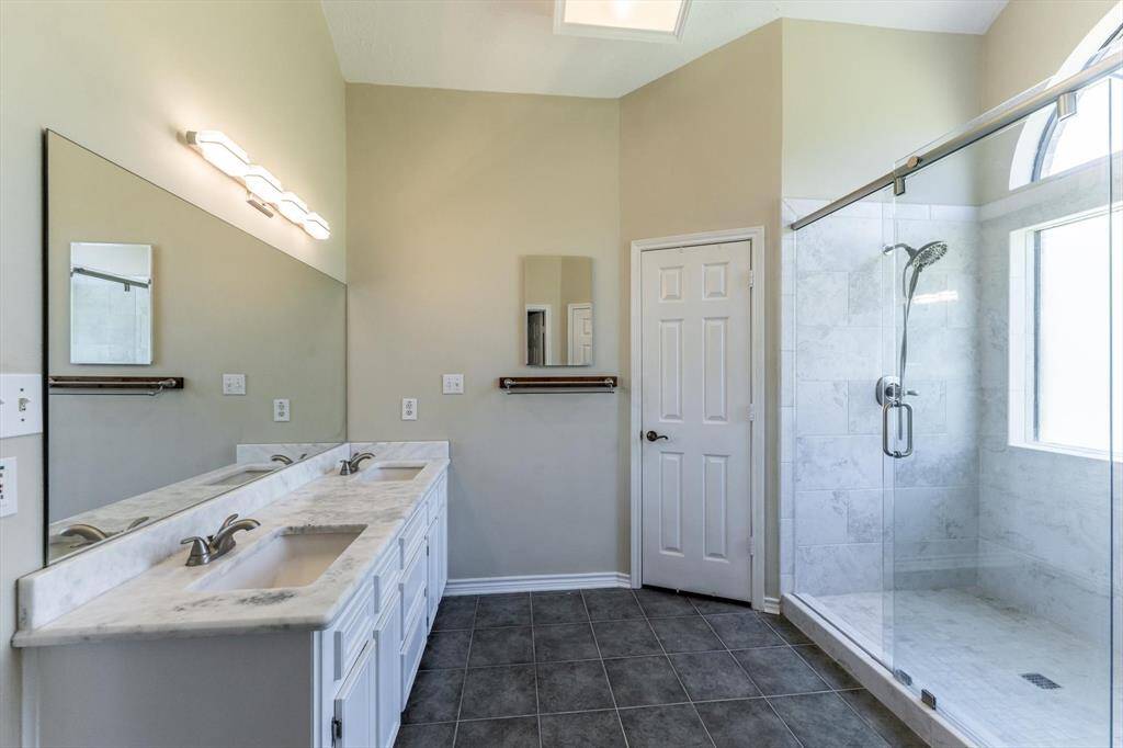Primary bath with double sinks and large walk-in shower