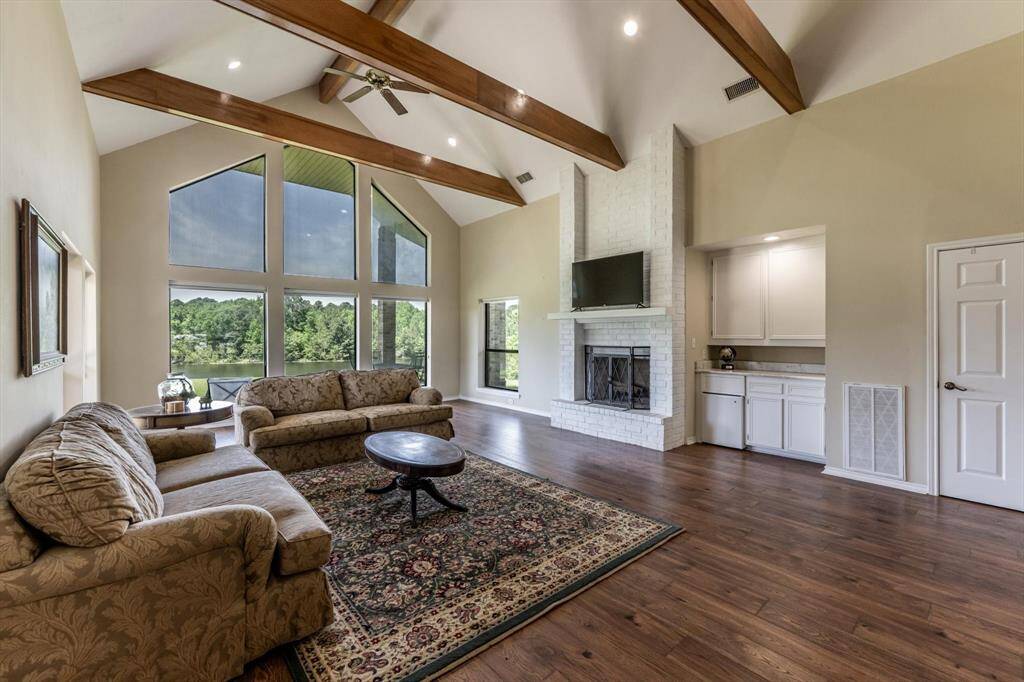 Living room with vaulted ceilings and windows overlooking the lake