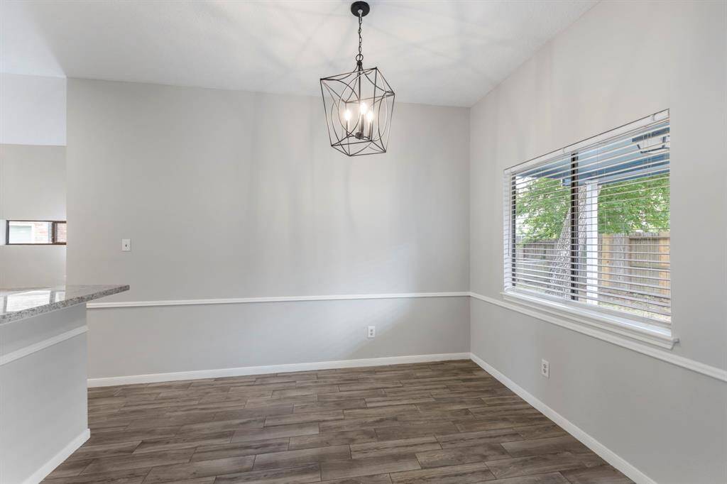 The living area seamlessly opens to the dining/breakfast room, leading into the kitchen