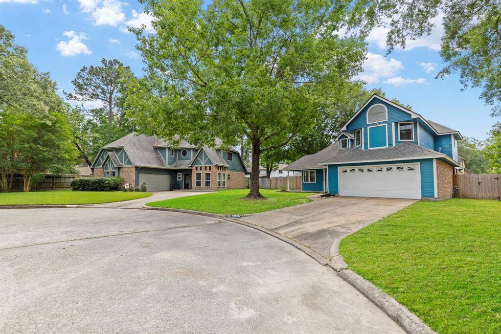 This home is located on a cul-de-sac and embraced by the natural beauty of mature trees