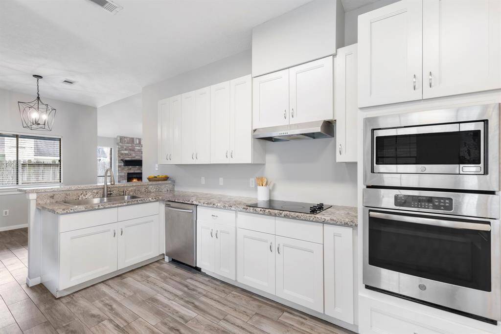 From the dining/breakfast room, enjoy the panoramic view of the living room, upstairs game room and kitchen