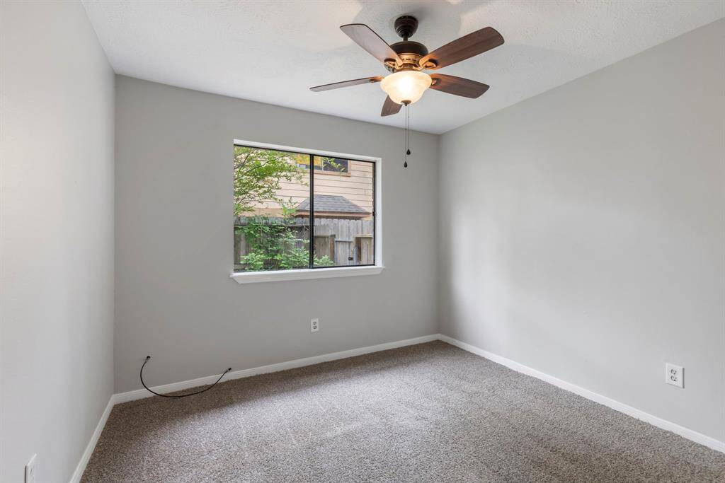 The freshly painted kitchen features a cozy seating area with just enough space for a small table, perfect for enjoying your morning coffee while gazing out the windows