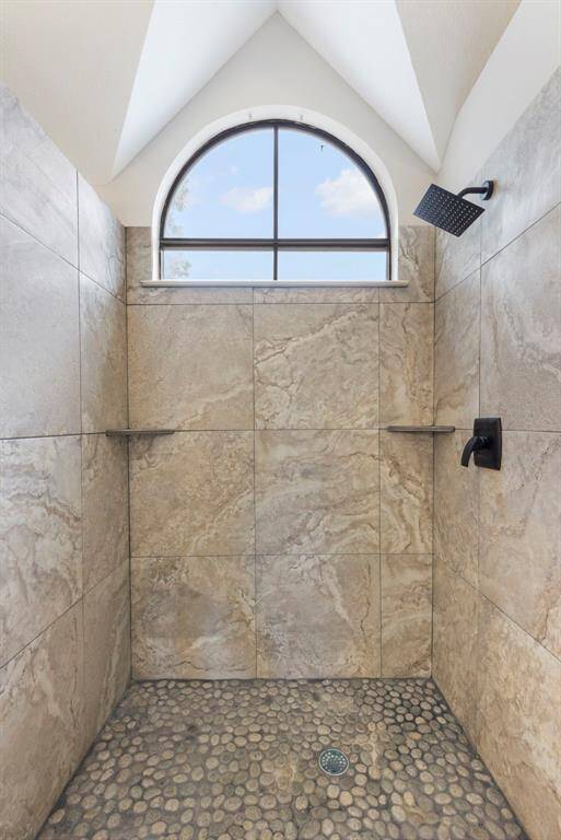 The updated primary bathroom boasts with modern fixtures, a spacious walk-in shower
