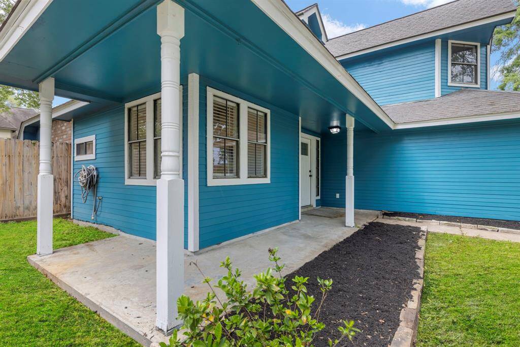 The expansive fenced-in backyard features two large shade trees that offer a perfect blend of privacy and tranquility for outdoor relaxation and play