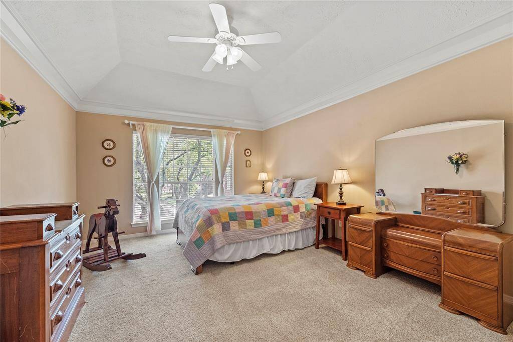 Third bedroom located on the second floor measures 15.11 x 16.6. It features an inviting atmosphere with carpeted flooring, a vaulted ceiling with a fan, and ample natural light from a large window.