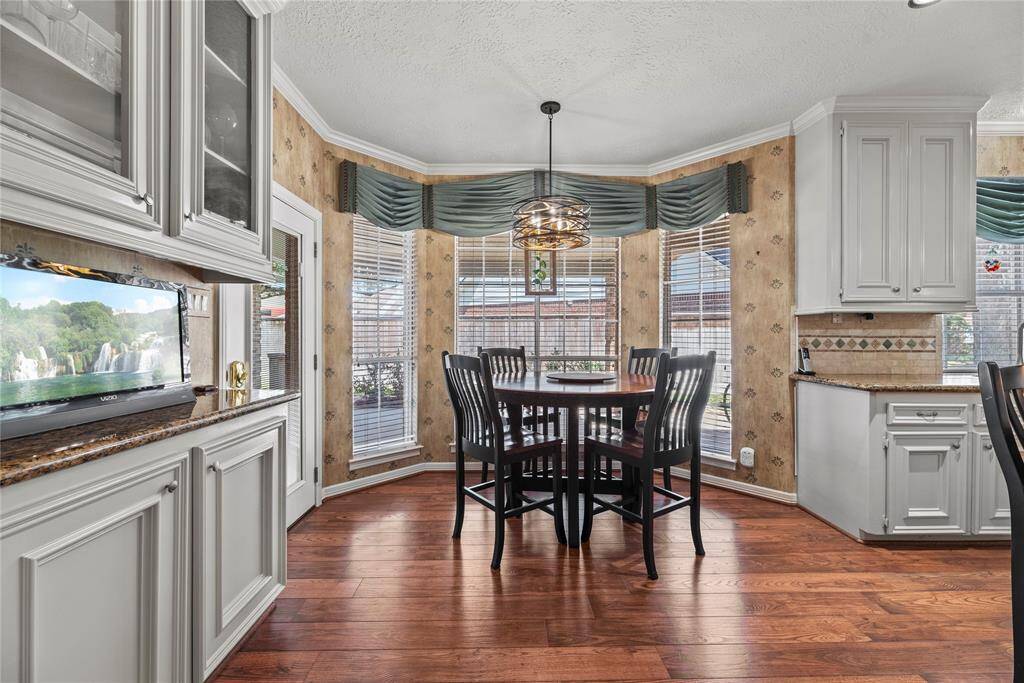 Breakfast nook adjacent to the kitchen, ideal for enjoying your morning coffee and pastries while taking in the serene backyard view.