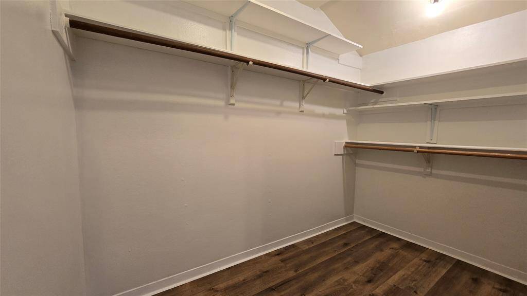 Primary Walk-in Closet: Spacious walk-in closet in the primary suite offers ample storage and organization.