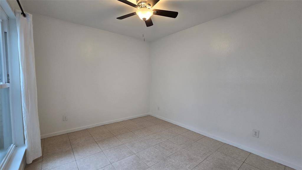 First-floor bedroom offers flexibility as a guest suite, office, or second primary with an adjacent full bath.