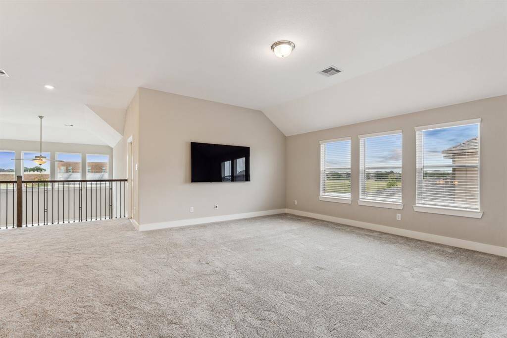 This huge game room is the perfect spot to relax and hang out. The mounted TV stays with the home!