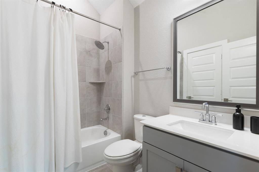 One of two full bathrooms located upstairs. This one has a door to a bedroom and also a door to the game room.