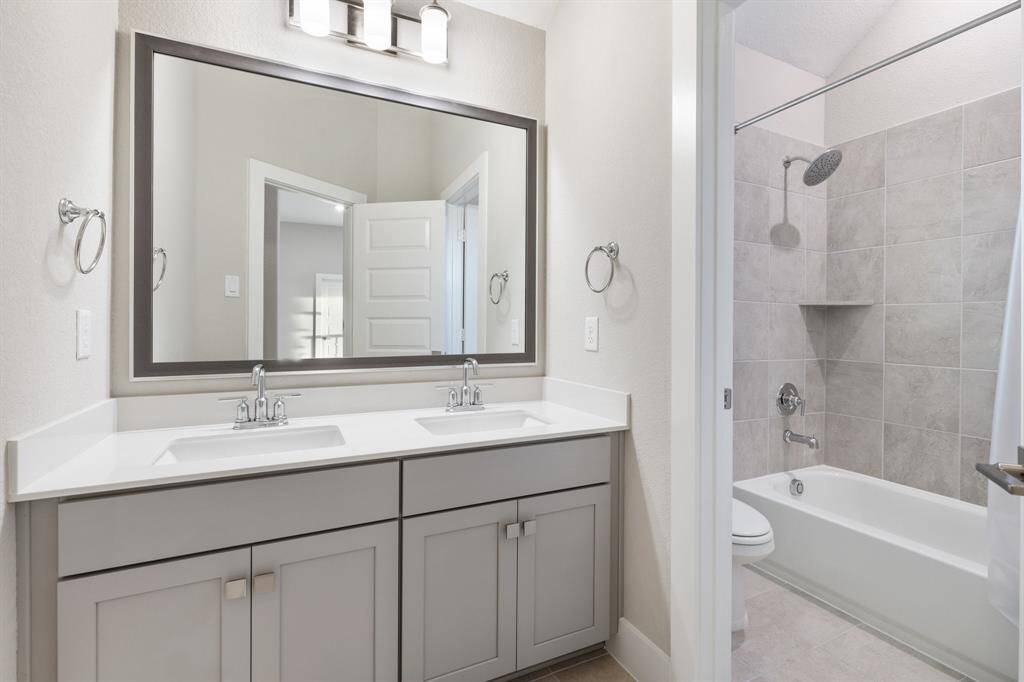 The second full bathroom located upstairs with two sinks and great storage.